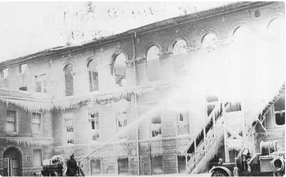 A fire engine spraying water on a buildingAI-generated content may be incorrect.